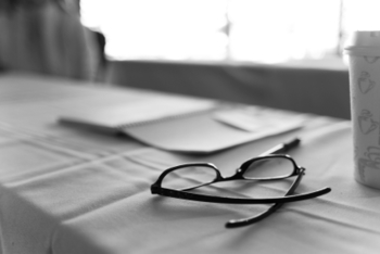 Spectacles and coffee cup in black and white