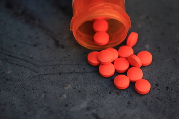 Spilled Orange Pills and Medicine Bottle