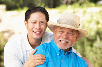 Senior Man With Adult Son In Garden