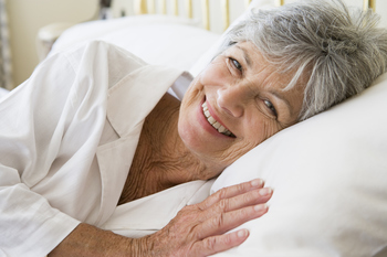 Woman lying in bed smiling