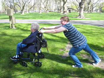 Ame trying to push Mom on the grass