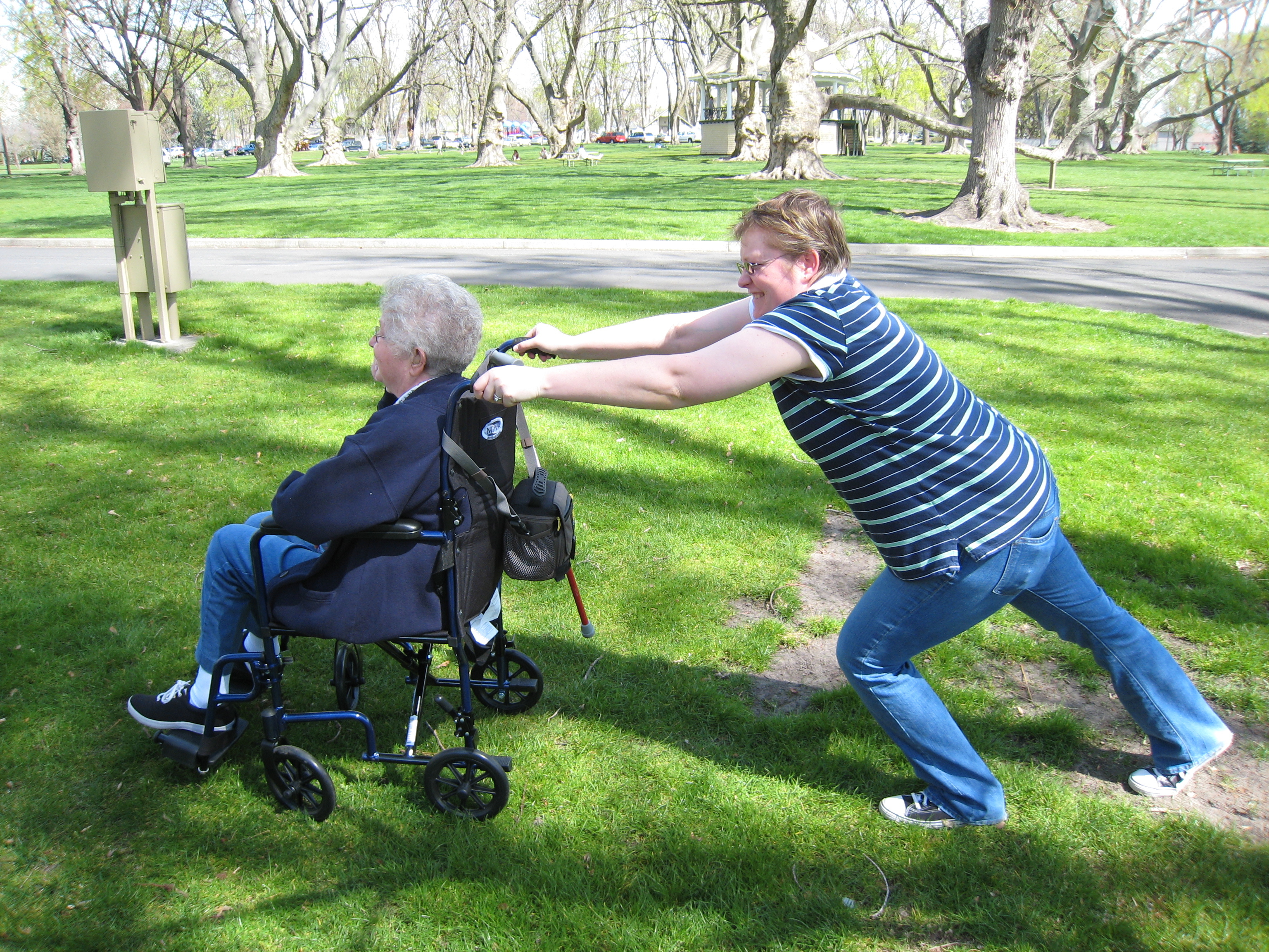 Ame trying to push Mom on the grass
