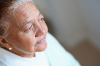 Worried old woman looking away thinking