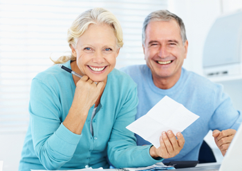 Happy senior couple planning household financials