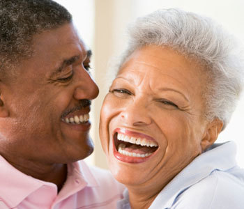 Couple relaxing indoors laughing